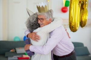 elderly man hugging elderly person