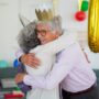 elderly man hugging elderly person
