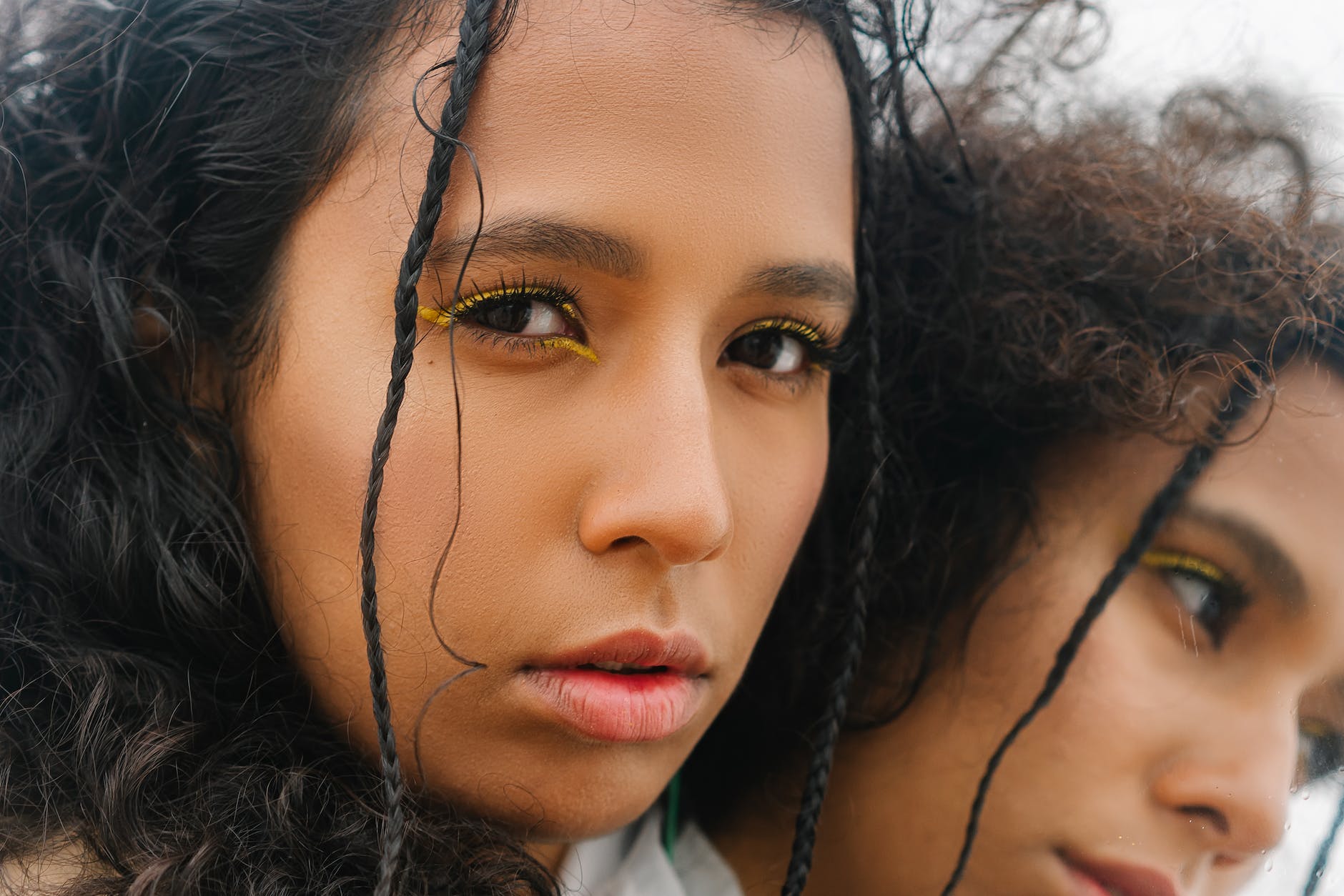 a woman with yellow eyeliner